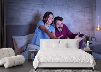 Couple having fun playing video games Wall mural