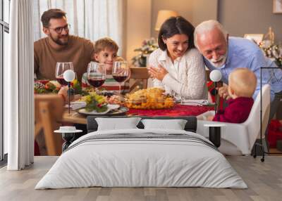 Family gathered at home for Christmas dinner Wall mural