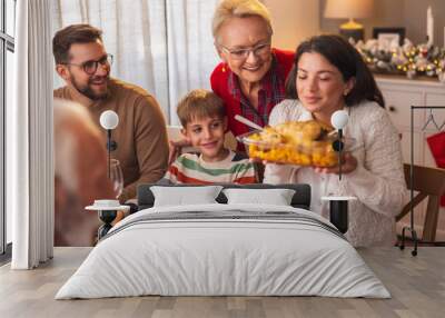 Mother and daughter placing food on the table for family Christmas dinner Wall mural