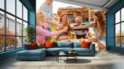 People making a toast at barbecue poolside backyard party Wall mural