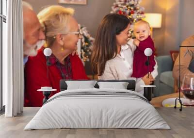 Senior couple having Christmas dinner with daughter and granddaughter Wall mural