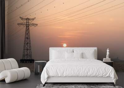 High voltage electricity tower in the ocean at sunset Wall mural