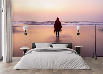 one person standing on the the beach in sunrise Wall mural