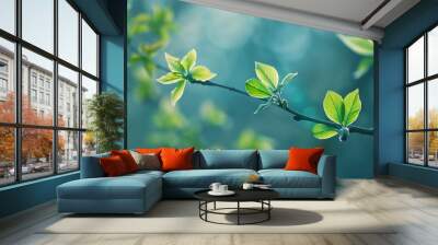 Green leaves emerging from a branch, signifying the arrival of spring and the beauty of new life. Wall mural