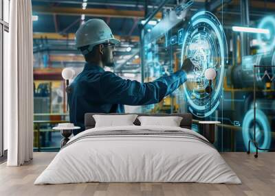 Industrial worker in a factory setting interacts with a digital interface. He is using his finger to touch a holographic display that displays technical information. Wall mural