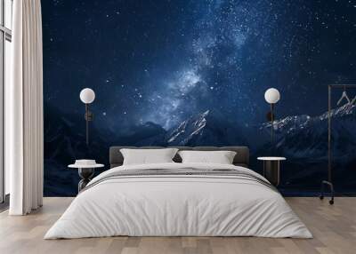 Milky Way galaxy shining brightly over a snow-capped mountain range on a clear night. Wall mural