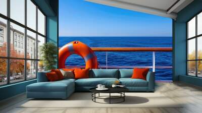 orange lifebuoy sits on the railing of a cruise ship at sea Wall mural