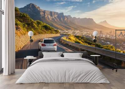 Luxury SUV driving on a scenic mountain road with a city view, ideal for travel promotions, road trip articles, or car advertisements, ai Wall mural