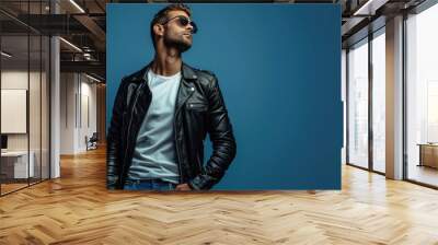 a man wearing a black jacket and white t-shirt, and wearing sunglasses Wall mural