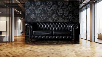 Photograph of a black vintage leather sofa in the center of a dark room with patterned wallpaper and antique furniture Wall mural