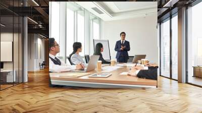 asian business man speaking during team meeting in office Wall mural