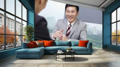 asian business people talking in office, looking excited Wall mural