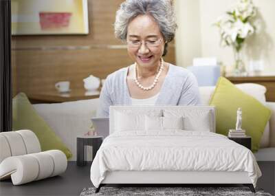 senior asian woman using tablet computer Wall mural