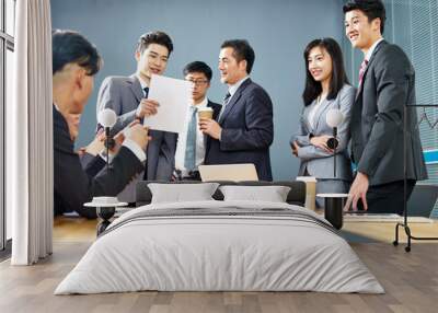 team of asian business people working together in office Wall mural