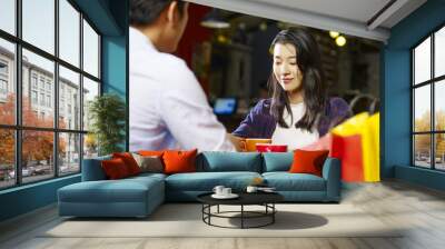 young asian couple talking face to face in coffee shop Wall mural