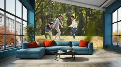 young asian family with two children enjoying outdoor activity Wall mural