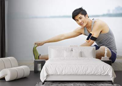 young asian man exercising outdoors Wall mural