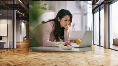 young asian woman female freelancer working at home Wall mural