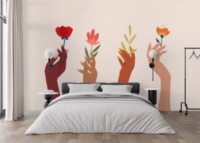 set of female hands holding beautiful flowers. different skin colored elegant woman hands isolated.  Wall mural