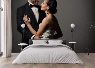 Couple Fashion Portrait, Embracing Man in Black Suit and Woman in White Dress Wall mural