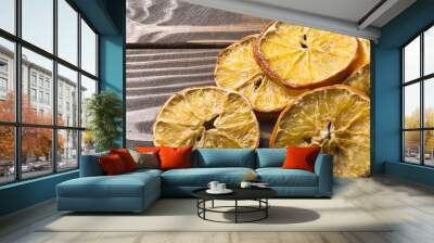 Dried orange and lemon slices on wooden background. rings of dried citrus on table. Wall mural