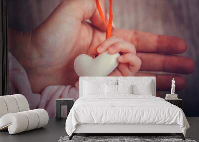 Mother and child hands holding white heart, health care love and family concept. World humanitarian day theme. Wall mural