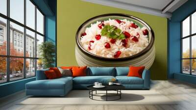 Healthy pomegranate rice on green background Wall mural