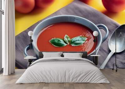 Healthy tomato soup in bowl on yellow background Wall mural