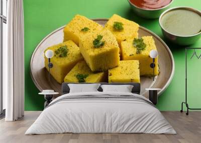 Indian traditional gujarati street food khaman dhokla on green background Wall mural