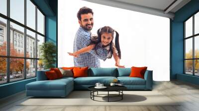 A FATHER CARRYING DAUGHTER IN ARMS WHILE PLAYING  Wall mural