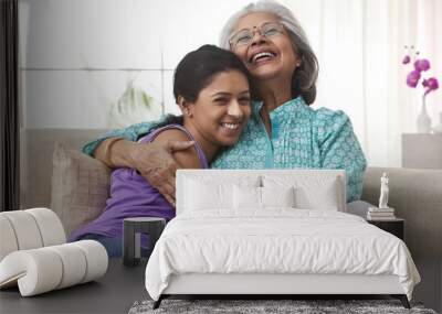 Grandmother hugging her granddaughter Wall mural