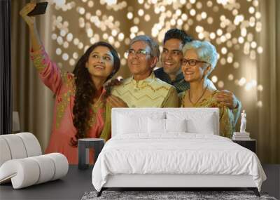 Indian family taking selfie or self photograph at home on diwali festival
 Wall mural