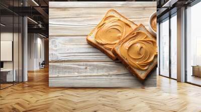 A Simple Yet Satisfying Snack Two Slices of Toasted Bread Spread with Creamy Peanut Butter, Presented on a Rustic Wooden Surface Wall mural