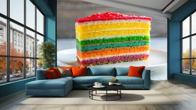 A single slice of rainbow layered cake, adorned with red sprinkles, sits on a white plate against a rustic backdrop. Wall mural