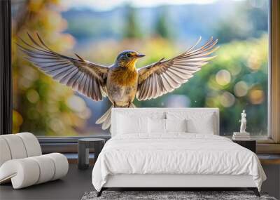 A small bird with its wings outstretched, hovers in front of a window pane, while sunlight streams in from outside. Wall mural