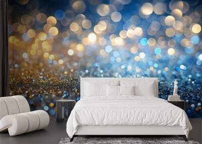 Abstract glitter lights in silver, blue, and gold shining on a blurred background Wall mural