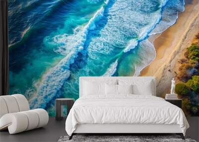 Aerial view of a tranquil blue beach with ocean waves crashing Wall mural