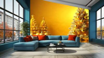 Bright yellow Christmas tree adorned with three shiny gold ornaments on top Wall mural