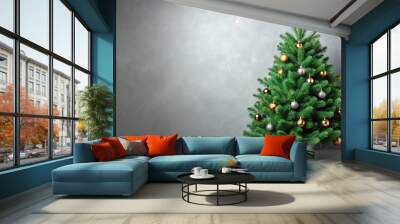 Green branches of a Christmas tree on gray background, perfect for a festive holiday card or background image Wall mural