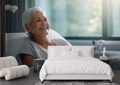 Senior female patient lying satisfied smiling at modern hospital patient bed. Excellent service at a for-profit hospital.  Wall mural