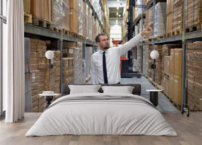 portrait friendly businessman/ manager in suit working in the warehouse of a company Wall mural