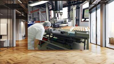 Production of pralines in a factory for the food industry - women working on the assembly line  Wall mural