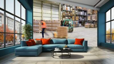 warehouse worker in a forwarding agency - interior with forklift - transport and storage of goods Wall mural