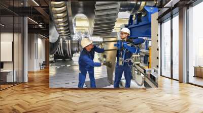 workers assembling and constructing gas turbines in a modern industrial factory Wall mural