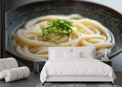 Minimalist presentation of Japanese udon noodles in a plain bowl with a hint of garnish simple and serene Wall mural