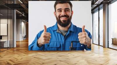 Positive engineer worker showing thumbs up on white background representing a sense of achievement and contentment with a confident expression Wall mural