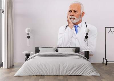 Image of worried  senior doctor thinking on gray background. Wall mural