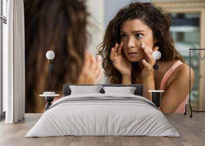 Tired woman looking her eye bags in the bathroom. Wall mural