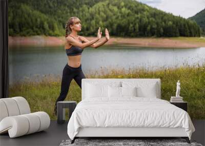 Woman exercise Tai Chi in the beautiful nature. Wall mural