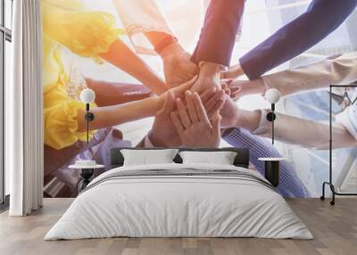 Underneath view of business people hands together concept. Wall mural